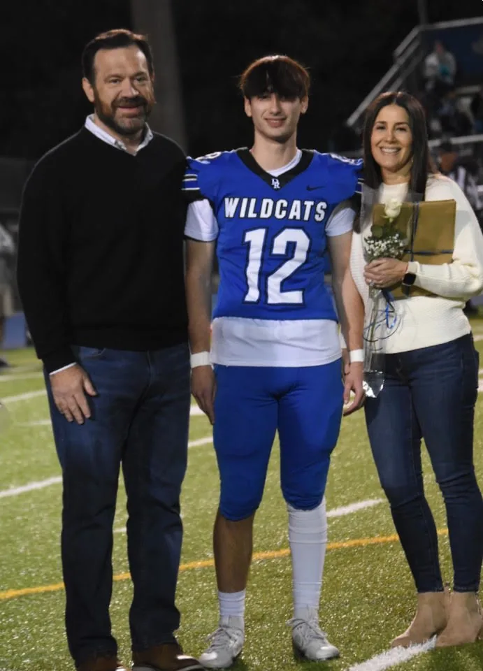 Gavin with his parents on senior night
